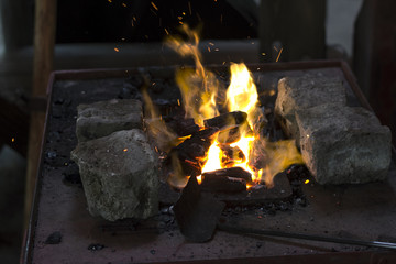 Heating steel pieces on blacksmiths fire place
