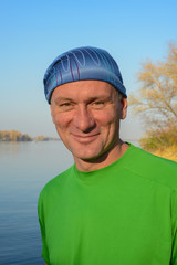 Portrait of  happy hiker on the background river. Autumn.