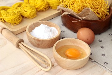 Making yellow noodle with egg and wheat flour.