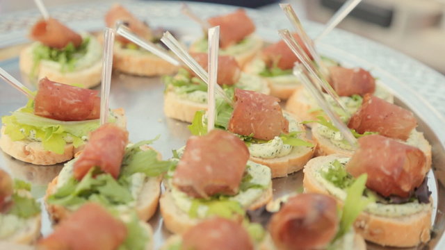 Sandwiches with cream cheese, leaf of lettuce and a piece of ham