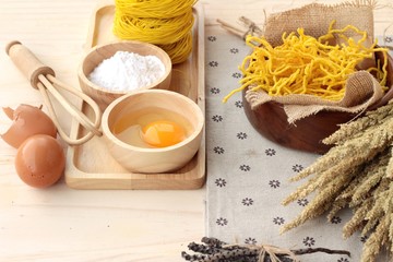 Making yellow noodle with egg and wheat flour.