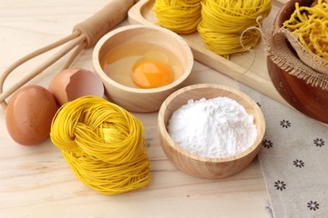 Making yellow noodle with egg and wheat flour.