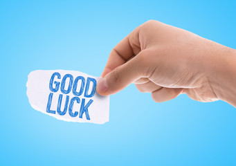 Piece of paper with the word Good Luck with blue background