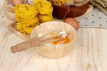 Making yellow noodle with egg and wheat flour.
