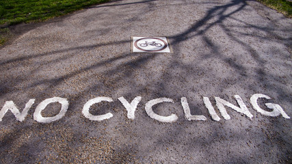 No cycling sign on road.