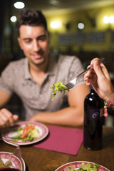Blurred man ready for eat salad at restaurant