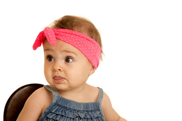 Beautiful baby girl wearing a pink polka-dot headband