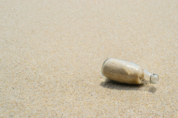 glass bottle on the sand beach