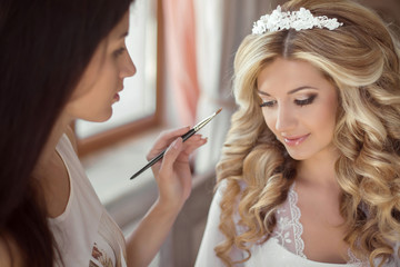 Beautiful bride wedding with makeup and hairstyle. Stylist makes