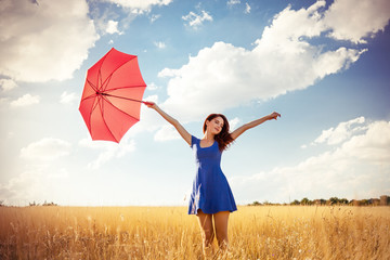 Beautiful redhead girl with umbrella