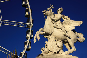 Statue of King of Fame riding Pegasus on the Place de la Concorde with ferris wheel at background,...