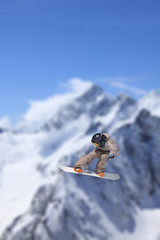 Flying snowboarder on mountains