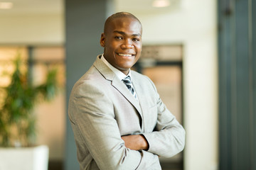 young african office worker with arms crossed