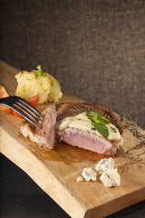 steak, a prepared piece of steak cut with blue cheese sauce on dining table decorated