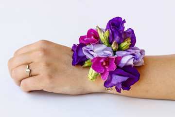 Wrist corsage made of violet and purple eustoma flowers