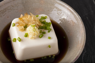 Japanese tofu, Japanese soft cold tofu with sauce in a dish on dining table