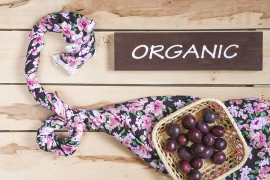 Ripe plums on the wooden background