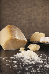 grated cheese, grated parmesan cheese with a grater and a jar and bottle of olive  oil