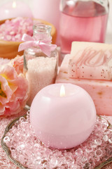 Obraz na płótnie Canvas Pink spa set: scented candle, bath caviar, bar of soap and liqui