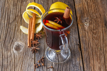 Mulled wine and spices on weathered wooden table