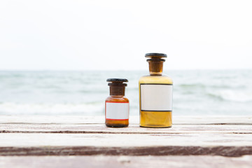Vintage medicine bottles on sea background
