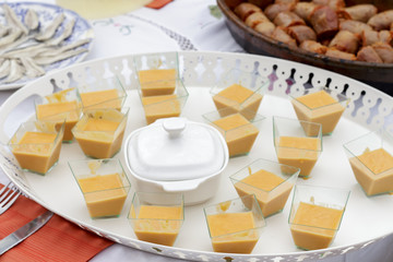 Tray of canapes of salmorejo beside spanish sausage and anchovies fillets