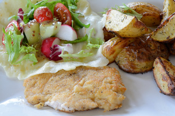Chicken cutlet, baked potatoes, salad and mozzarella cheese.