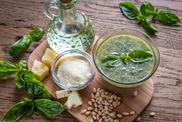 Pesto with ingredients on the wooden table