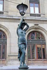 Bronze lamppost shaped as antique caryatide near Palais Garnier, the Paris Opera House in Paris,...