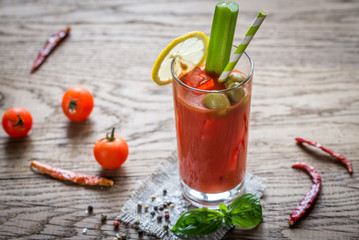 Bloody Mary cocktail on the wooden background