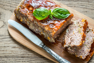 Meat loaf with barbecue sauce on the wooden board