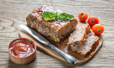 Meat loaf with barbecue sauce on the wooden board