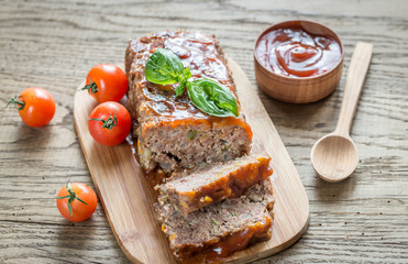 Meat loaf with barbecue sauce on the wooden board
