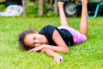 African girl playing on meadow