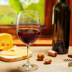 Glass and bottle of wine on table
