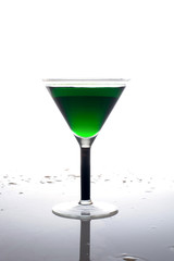 glass of green drink on a white background