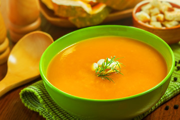Pumpkin Soup with croutons and ingredients on table