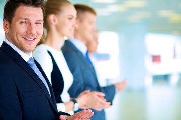 Smiling business people applauding a good presentation in the