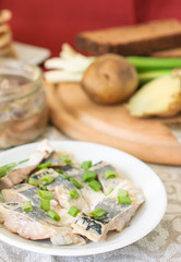 Pickled herring with green green onions and fennel.