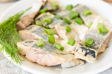 Pickled herring with green green onions and fennel.