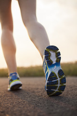 Naklejka premium Runner feet running on road closeup on shoe