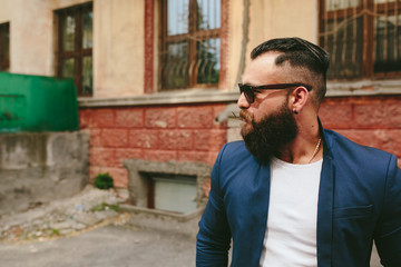 Stylish bearded man walks through the city