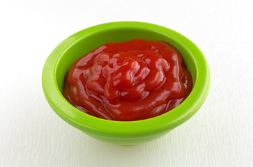 Ketchup in a small green bowl