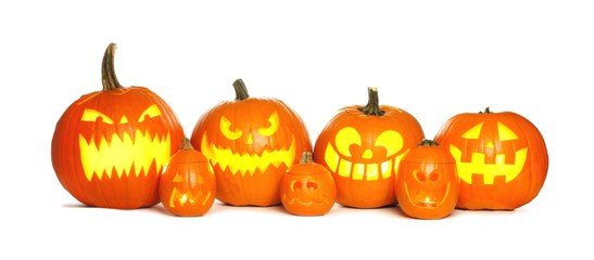 Row of fun lit Halloween Jack o Lanterns isolated on a white background
