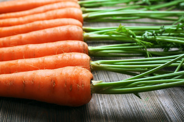 Fresh organic carrots on wooden table, closeup