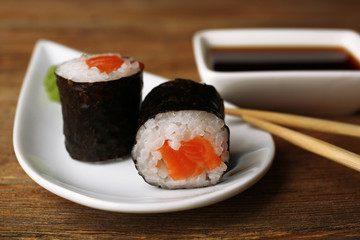 Rolls with sauce and sticks on wooden table close up