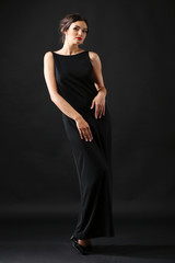 Retro style photo of young woman on dark background