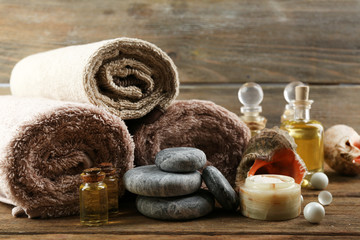 Stack of spa stones and spa treatments on wooden background