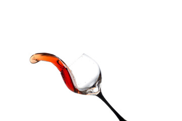 stream of wine being poured into a glass isolated on a white background
