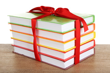 Fototapeta premium Stack of books with ribbon on light background